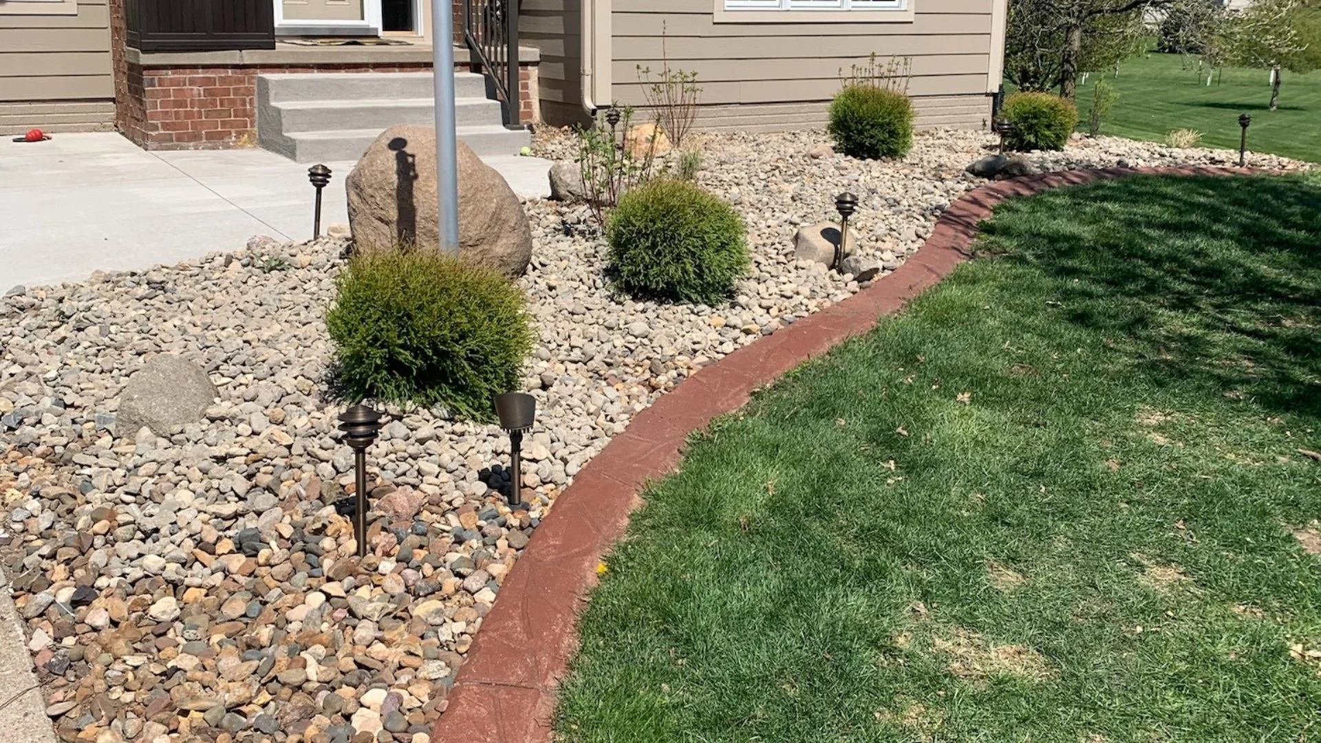 Landscape Bed With Plants, Boulders & Lighting in Polk City, IA