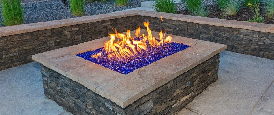 Gas-burning fire pit in Ankeny, IA, with a seating wall.