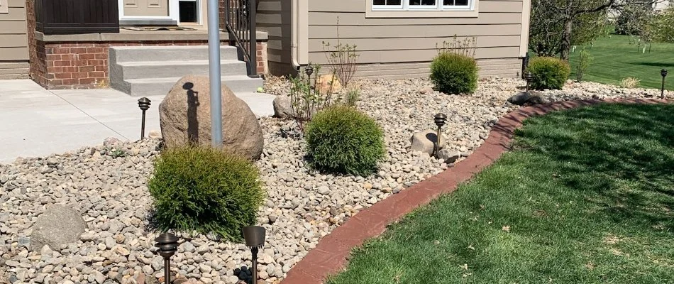 Landscape bed in Ankeny, IA, with shrubs and full sunlight.