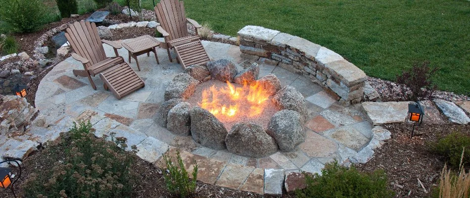 Seating wall and chairs around a fire pit in Ankeny, IA.