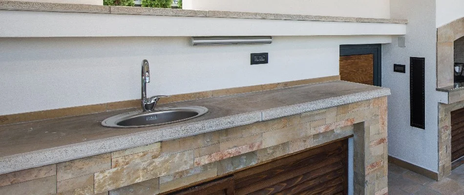 Sink in an outdoor kitchen countertop in Ankeny, IA.