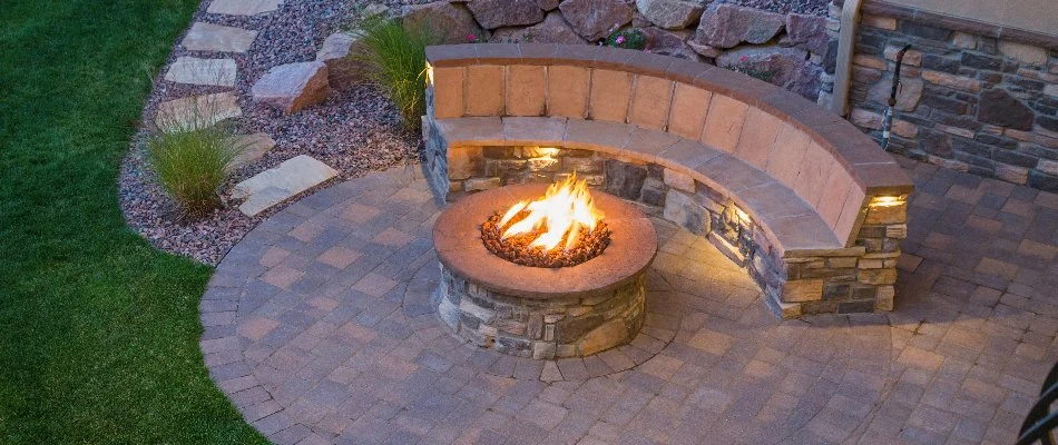 A fire pit next to a seating wall in Ankeny, IA.