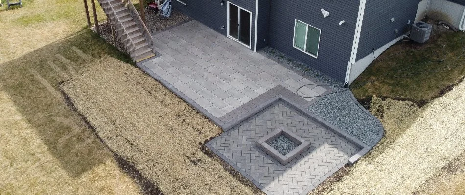 House in Cedar Rapids, IA, with a patio, fire pit, and seating wall.