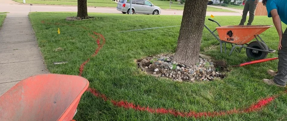 Landscape bed being mapped out with paint on a property in Bondurant, IA.