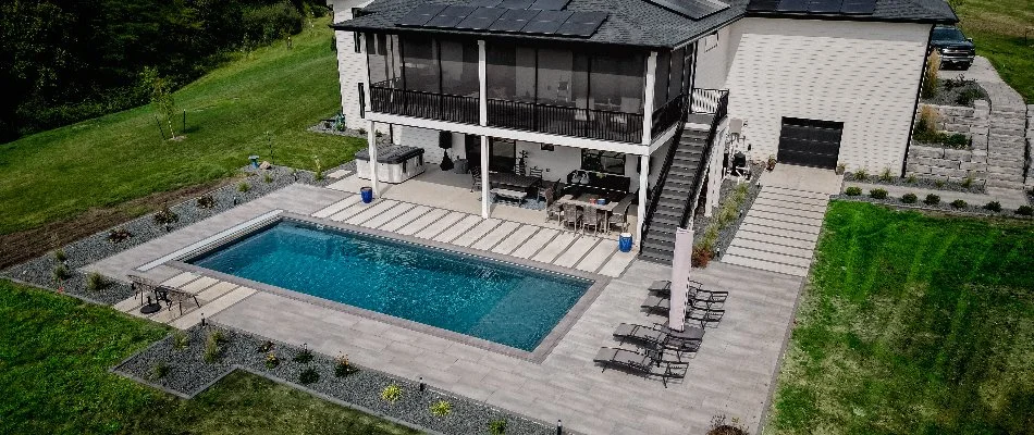 Custom patio around a beautiful, blue swimming pool in Elkhart, IA.