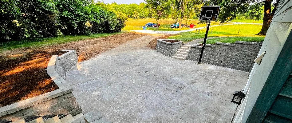 Image of a recently completed concrete patio with retaining walls and steps, ideal for outdoor living in %%areatarget1%%, IA