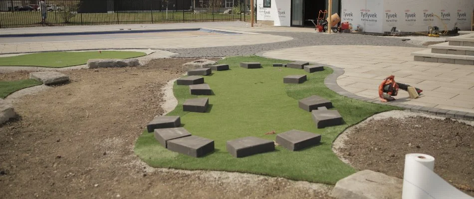 Artificial turf being installed on a property in Ankeny, IA.