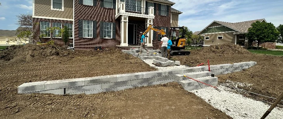 Retaining wall and step installations in progress on a property in Bondurant, IA.