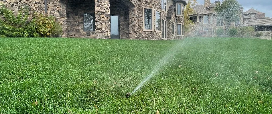 Sprinkler head watering grass in Lake Panorama, IA.