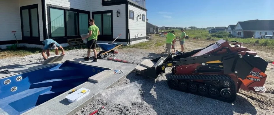 Workers installing a pool on a property in Ankeny, IA.