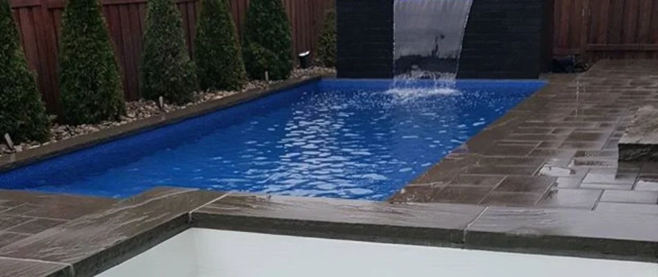 Outdoor living area with custom pool in Grimes, IA.